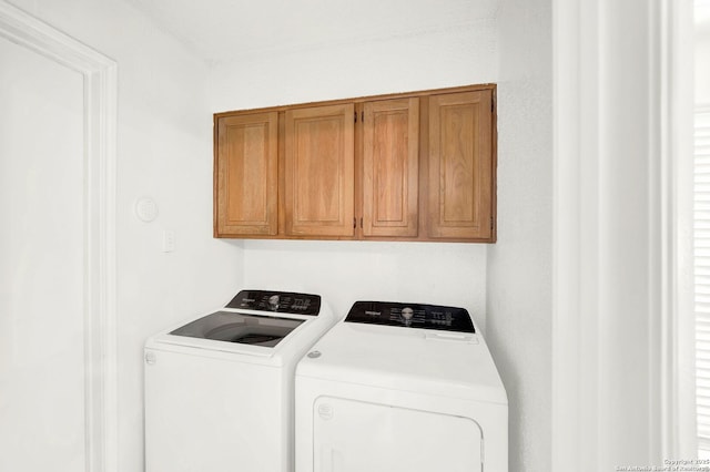 laundry room with cabinet space and separate washer and dryer