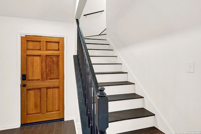 stairway with wood finished floors