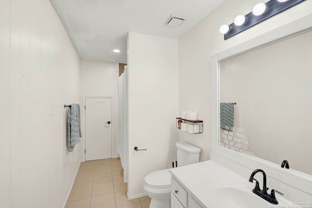 bathroom featuring vanity, visible vents, tile patterned flooring, a textured ceiling, and toilet