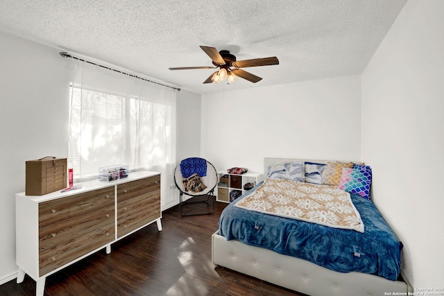 bedroom featuring a textured ceiling, ceiling fan, and wood finished floors