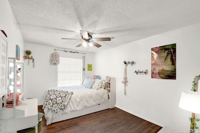 bedroom with a textured ceiling, wood finished floors, and a ceiling fan