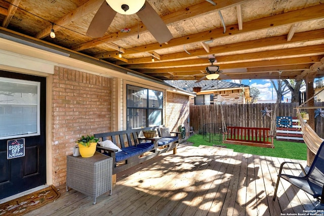 wooden deck with ceiling fan and fence