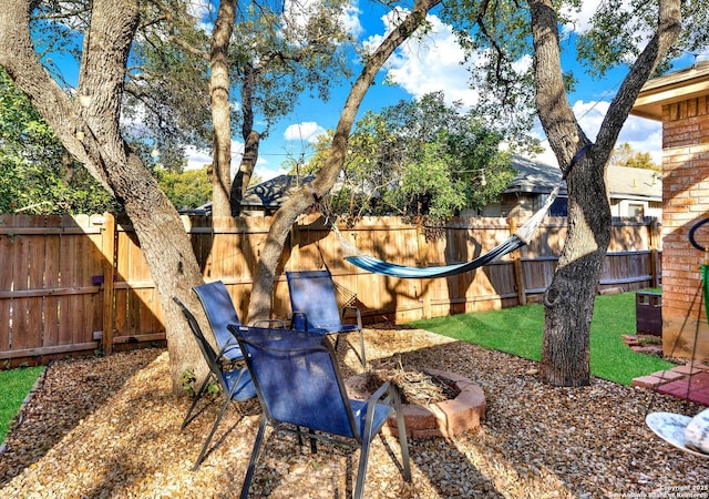 view of yard featuring a fire pit and a fenced backyard