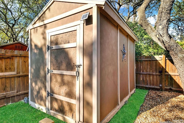 view of shed featuring fence