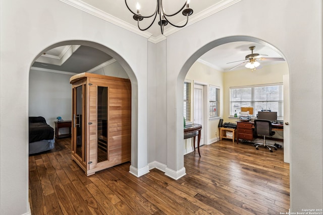 office featuring dark wood finished floors, ceiling fan with notable chandelier, baseboards, and ornamental molding