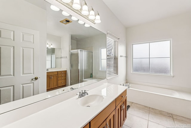 bathroom with a garden tub, vanity, a shower stall, and tile patterned flooring