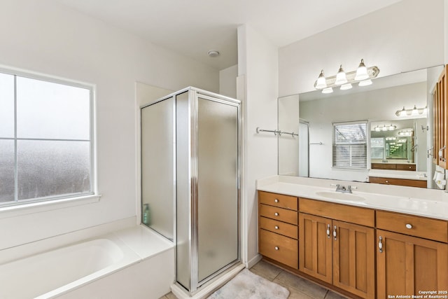 full bath with tile patterned flooring, a garden tub, vanity, and a stall shower