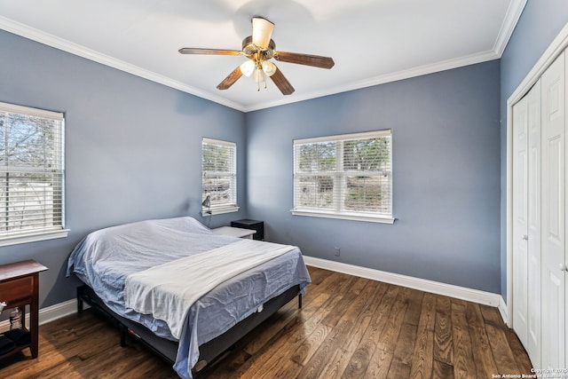 bedroom with baseboards, wood finished floors, and ornamental molding