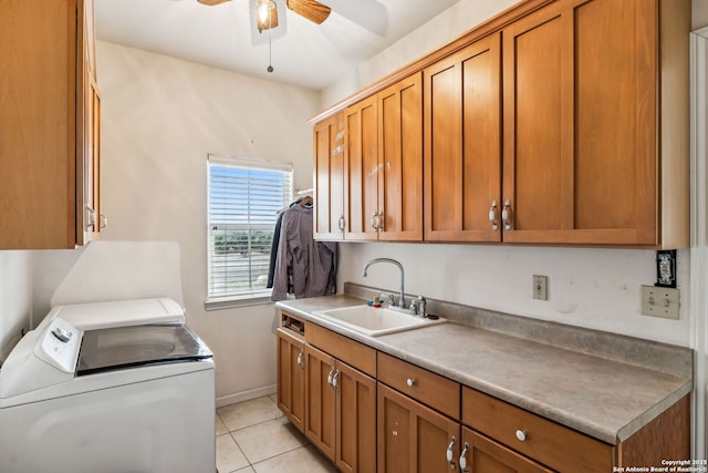 clothes washing area with ceiling fan, light tile patterned floors, cabinet space, independent washer and dryer, and a sink