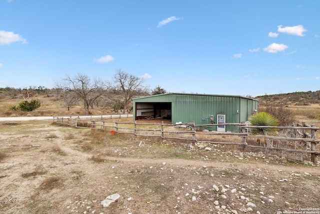 view of pole building with fence