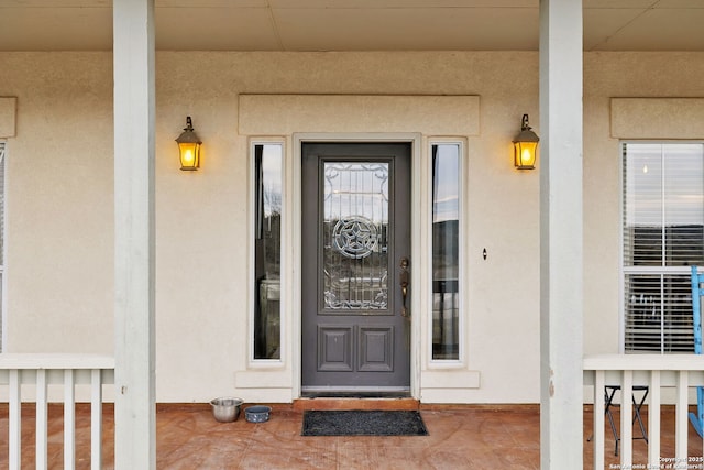 view of exterior entry featuring stucco siding