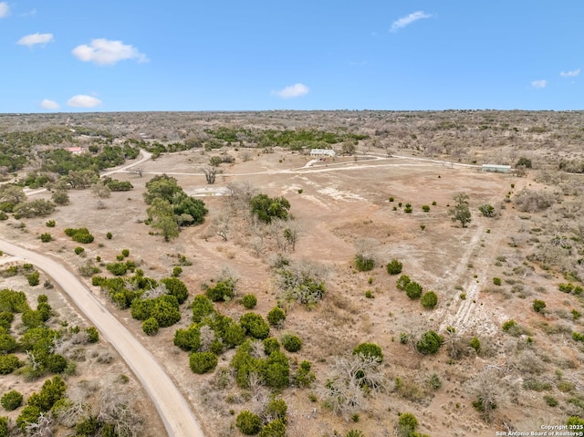 drone / aerial view featuring a rural view and a desert view