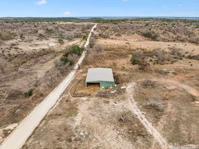 drone / aerial view featuring a desert view and a rural view