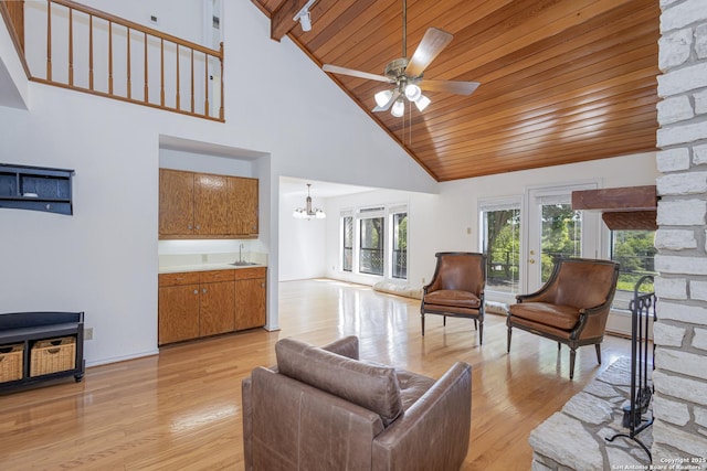 living room with wooden ceiling, light wood finished floors, and ceiling fan with notable chandelier