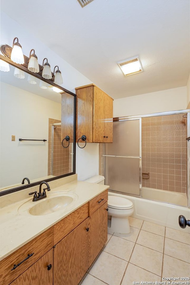 bathroom featuring tile patterned flooring, visible vents, vanity, toilet, and shower / bathing tub combination