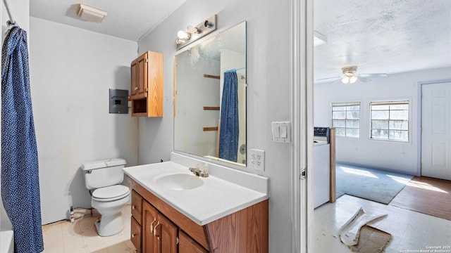 bathroom with vanity, a ceiling fan, a textured ceiling, curtained shower, and toilet