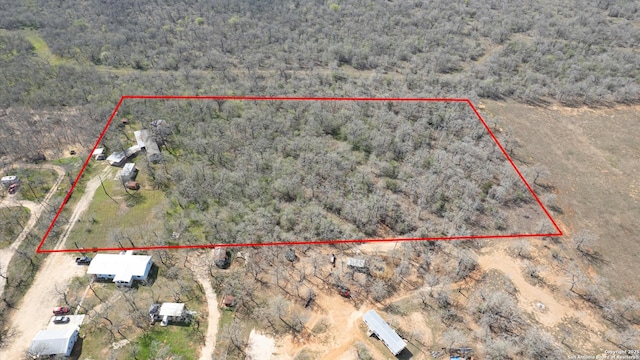 birds eye view of property featuring a forest view