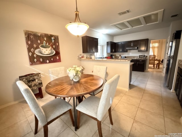 dining area with light tile patterned floors, visible vents, and baseboards