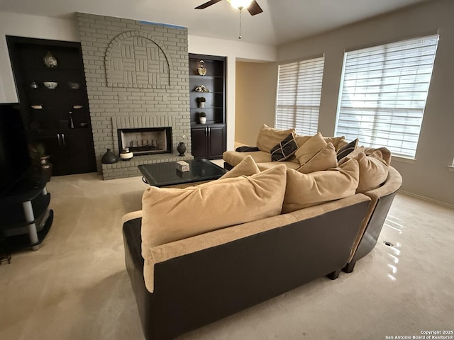 carpeted living room featuring a brick fireplace, built in features, a ceiling fan, and baseboards