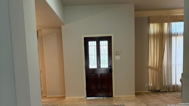 foyer entrance featuring baseboards