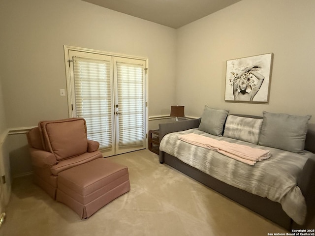 living area with french doors and light carpet