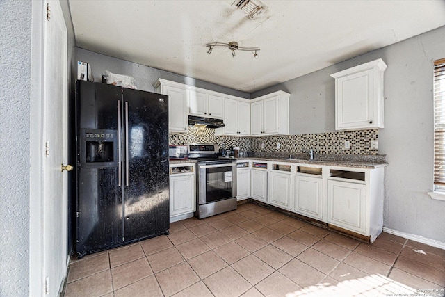 kitchen with light tile patterned floors, stainless steel range with electric cooktop, under cabinet range hood, tasteful backsplash, and black fridge