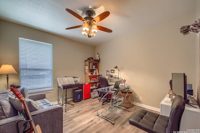 office featuring a ceiling fan, baseboards, and wood finished floors