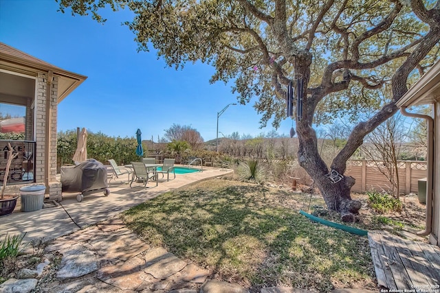 view of yard with a patio area, a fenced in pool, and a fenced backyard