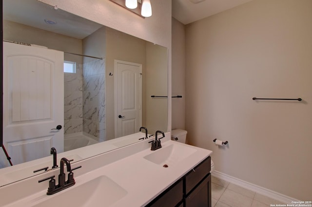 bathroom with double vanity, baseboards, and a sink