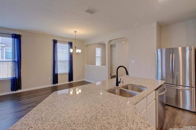 kitchen with dark wood-style floors, visible vents, a sink, stainless steel appliances, and white cabinets