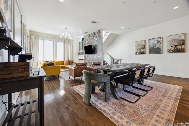 dining room featuring visible vents, stairs, an inviting chandelier, baseboards, and dark wood-style flooring