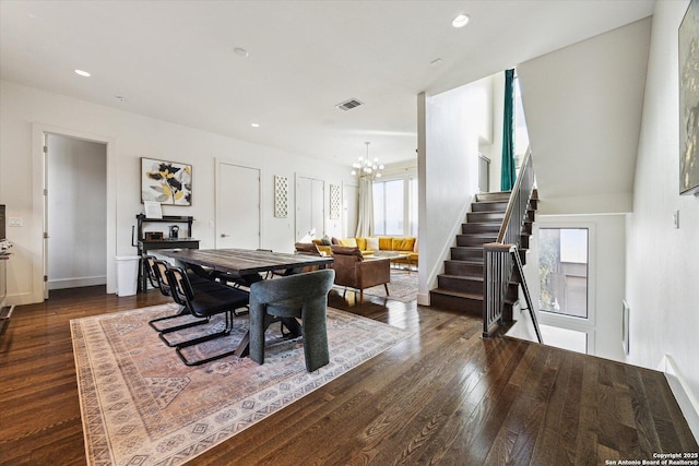 dining area with an inviting chandelier, a healthy amount of sunlight, and dark wood-style flooring