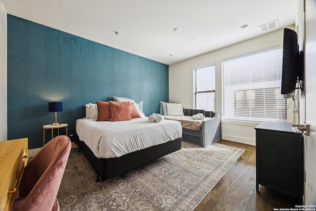 bedroom with visible vents, hardwood / wood-style floors, recessed lighting, wallpapered walls, and baseboards