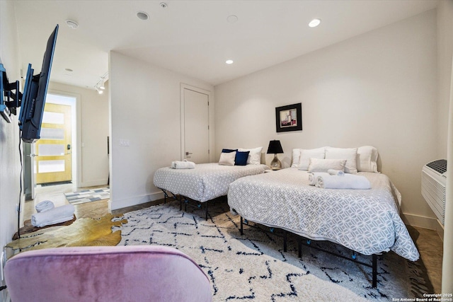 bedroom with recessed lighting, baseboards, and wood finished floors