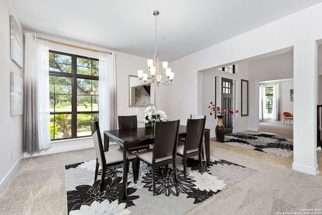 dining space featuring carpet flooring and baseboards