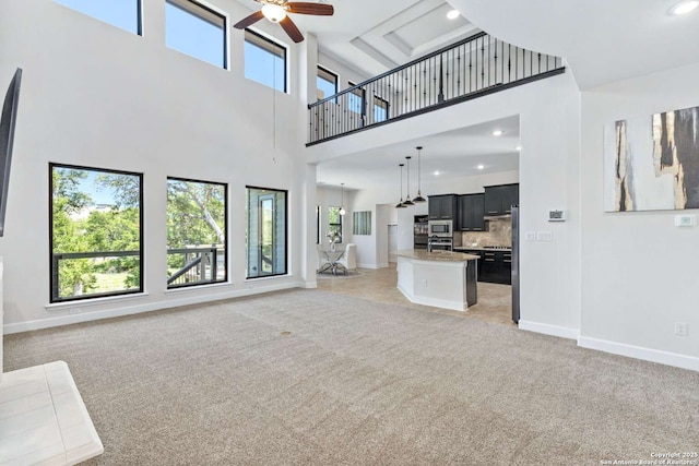 unfurnished living room featuring recessed lighting, light colored carpet, a ceiling fan, and baseboards