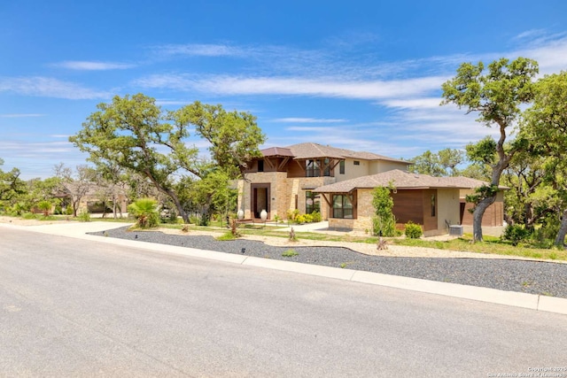 prairie-style house featuring stone siding