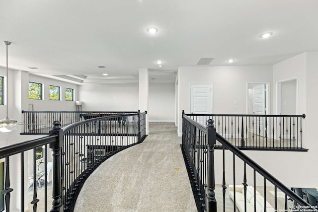 corridor featuring recessed lighting, an upstairs landing, visible vents, and carpet floors