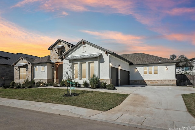 view of front facade featuring a front lawn, a standing seam roof, stone siding, an attached garage, and metal roof