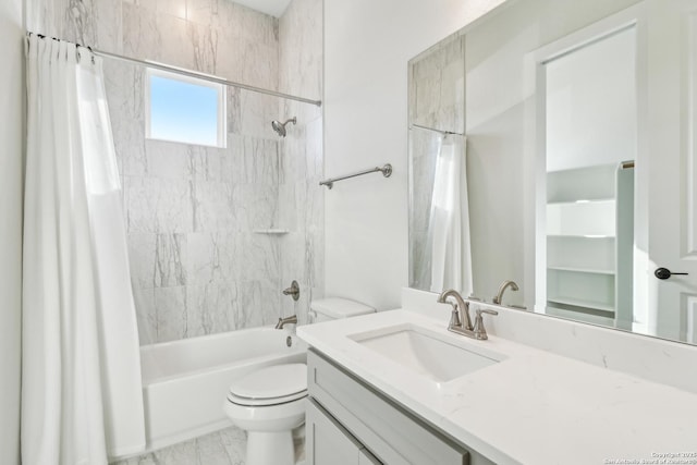 full bathroom featuring marble finish floor, vanity, toilet, and shower / bath combo with shower curtain