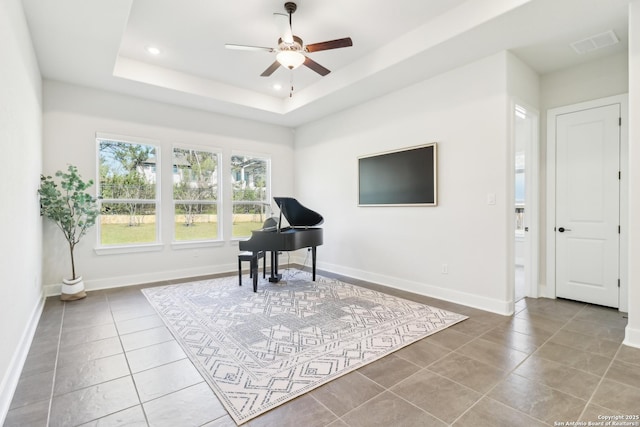 sitting room featuring tile patterned flooring, visible vents, baseboards, a tray ceiling, and recessed lighting