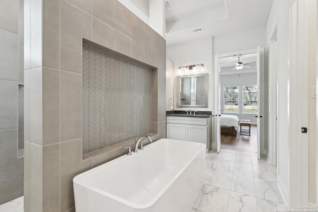 ensuite bathroom with visible vents, a soaking tub, a sink, ensuite bathroom, and marble finish floor