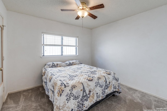 carpeted bedroom with a textured ceiling and ceiling fan