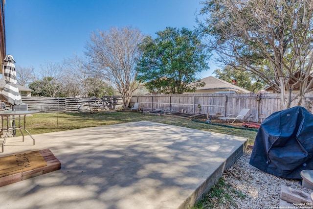 view of patio with area for grilling and a fenced backyard