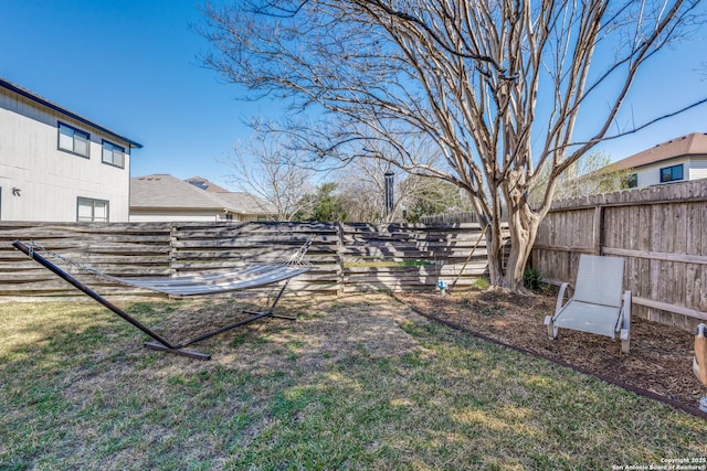 view of yard with a fenced backyard