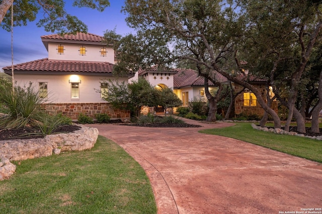 133 Fair Spgs, Boerne, TX 78006 - mediterranean / spanish home with stucco siding, a lawn, a tile roof, and stone siding