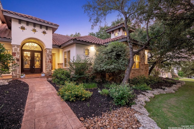 133 Fair Spgs, Boerne, TX 78006 - view of front of property featuring a tiled roof, stucco siding, stone siding, and french doors