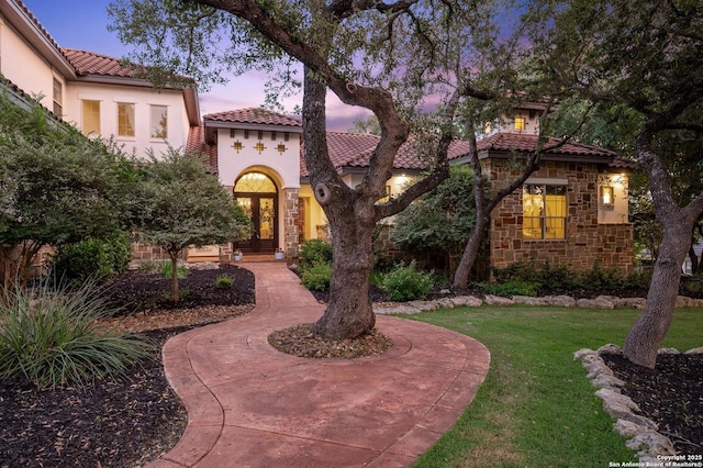 133 Fair Spgs, Boerne, TX 78006 - mediterranean / spanish-style home with stone siding, a lawn, a tile roof, and stucco siding