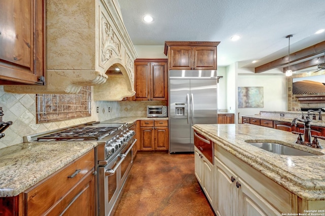 133 Fair Spgs, Boerne, TX 78006 - kitchen featuring appliances with stainless steel finishes, a sink, finished concrete floors, decorative backsplash, and recessed lighting