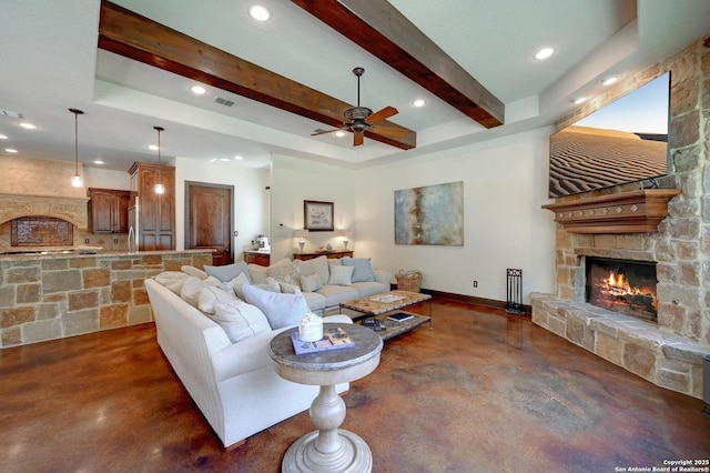 133 Fair Spgs, Boerne, TX 78006 - living room with concrete floors, a stone fireplace, ceiling fan, recessed lighting, and beam ceiling